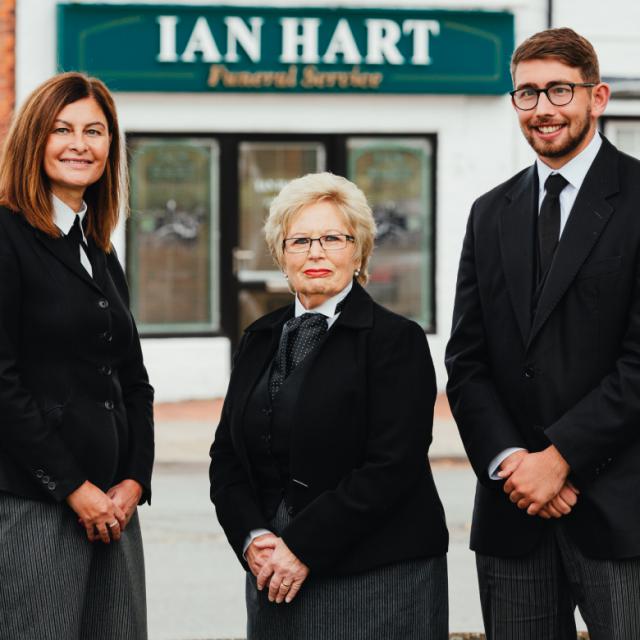 two females and a male member of staff stood outside ian hart funeral services